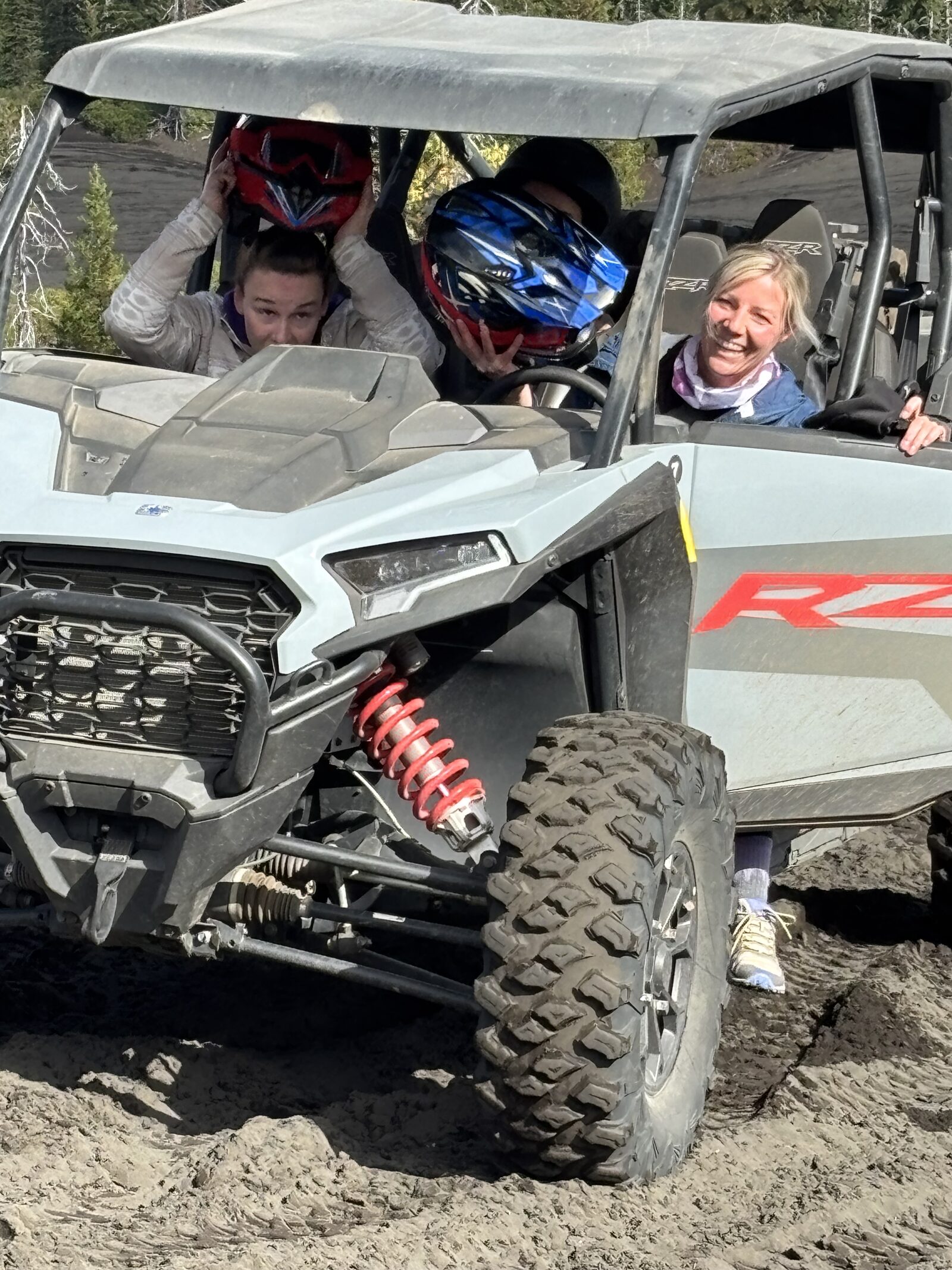 Guests smiling in the side-by-side ATV on the Black Sands trail